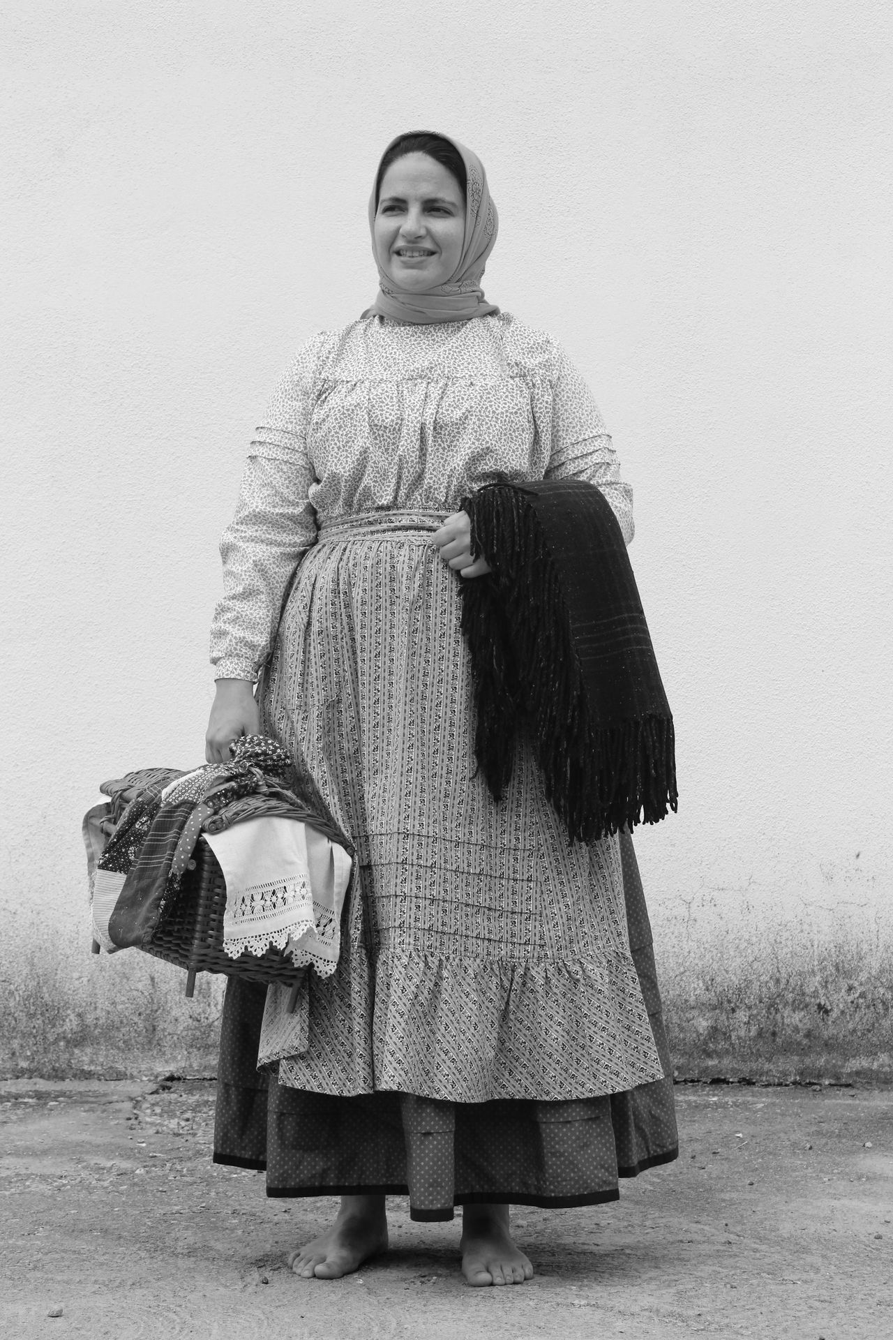 grayscale photo of woman holding handbag and scarf